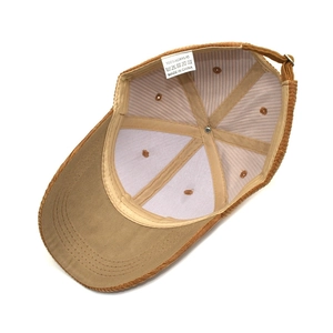 Detailed interior of the corduroy baseball cap showing the 100% acrylic care label