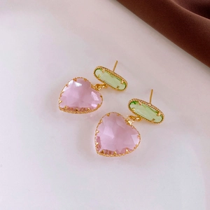 Detail of pink heart and green oval crystals set in vintage gold beaded earring frames
