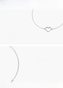 Macro shot of mirror-polished S925 sterling silver minimalist heart charm link bracelet