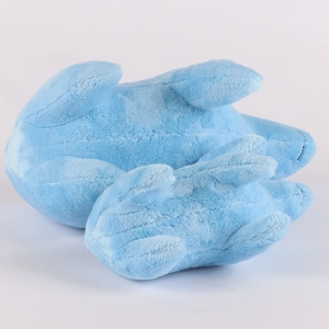 Close-up of plush capybara toy showing detailed stitching on paws and tail from bottom view