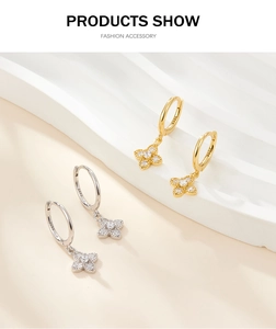 Close-up of S925 sterling silver four-leaf clover hoop earrings with pavé zircon stones