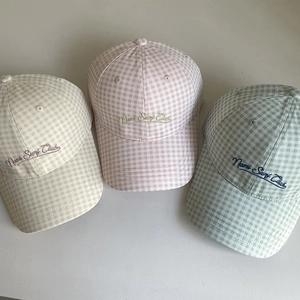 Detailed embroidery of Nami Surf Club on three colorful gingham cotton baseball caps
