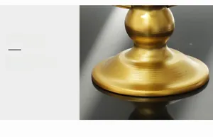 Detail of a stable wide circular base in gold electroplated metal with smooth texture