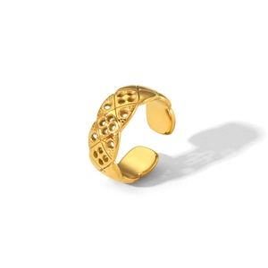 Detailed view of an open gold stainless steel ring with a classic quilted lattice design
