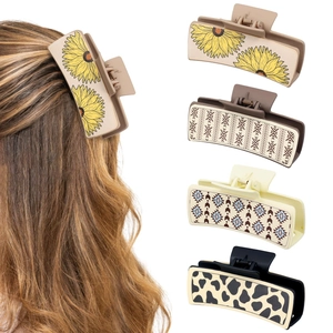 Detail showing various patterns like sunflower and leopard print on leather hair claws