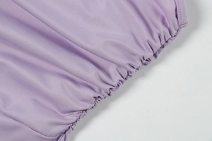 Detail of lavender ribbed fabric with elegant ruched edges and flexible stretch texture