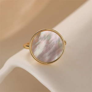 Close-up of heart-shaped iridescent mother of pearl set in a gold-plated copper ring