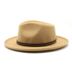 Close-up of camel wool fedora hat with a leather band and gold metal rivet details