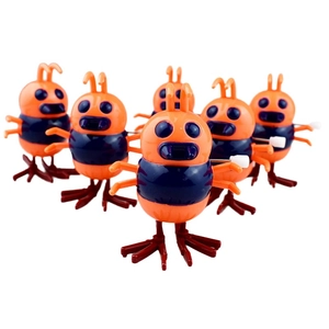 Detail of colorful wind-up insect toys in orange and blue with white rotating knobs
