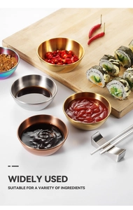 Four colorful stainless steel sauce bowls with various dips on a wooden board with sushi