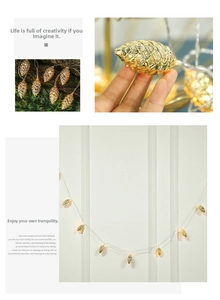 Detailed close-up of LED pinecone string lights with golden metallic texture and warm glow