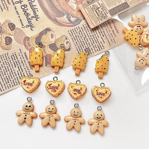 DIY resin jewelry pendants featuring ice cream, heart and gingerbread man shapes