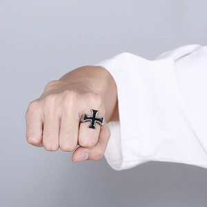 Detailed close-up of a men's vintage stainless steel cross ring with black enamel drip