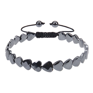 Macro shot of heart-shaped magnetic hematite beads with adjustable black braided cord strap