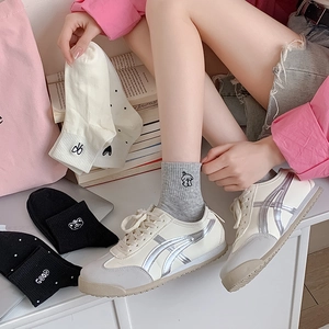 White casual sneakers with silver stripes and assorted embroidered cotton socks with bow and dots
