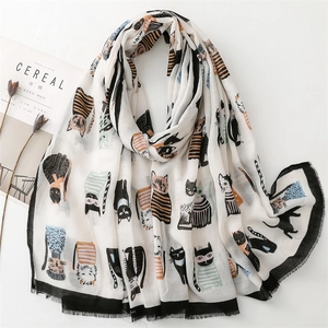 Detail view of a white scarf with cute hand-drawn cat illustrations and black border