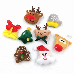 Detailed flat lay of plush Christmas ornaments including Santa, reindeer, and trees