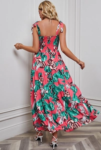 Detail of bohemian floral maxi dress featuring backless elastic bodice and tiered skirt