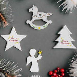 Detail of Christmas tree, star, rocking horse, and angel silicone resin molds in white