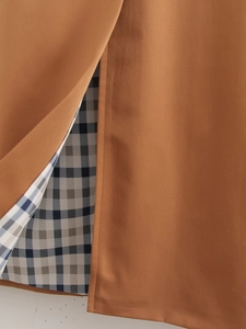 Detail of caramel twill fabric and blue checkered lining with precise stitching quality