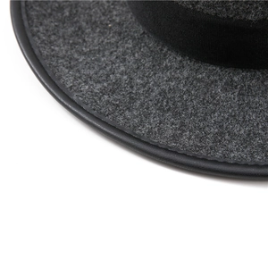Detailed macro view of grey wool felt cowboy hat with black leather edge and ribbed ribbon