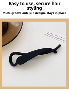 Detail of matte black torsion hair clip with multi-toothed non-slip design for secure hold
