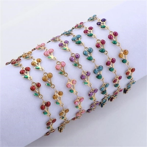 Detail of multi-color cherry pendants on 18k gold-plated stainless steel chain bracelets
