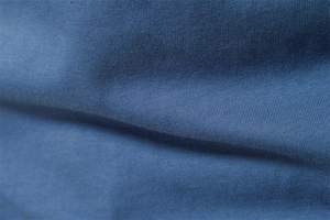 Macro view of blue cotton knitted fabric texture on long sleeve t-shirt