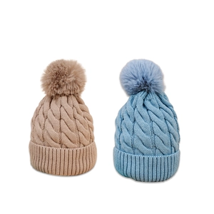 Winter cable knit pom-pom beanies in khaki and light blue with soft ribbed cuffs