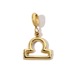 Macro detail of gold-plated stainless steel Libra zodiac pendant with polished finish