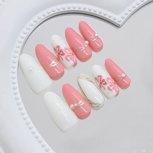 Pink and white long almond press-on nails with 3D pearl flower and gold accents