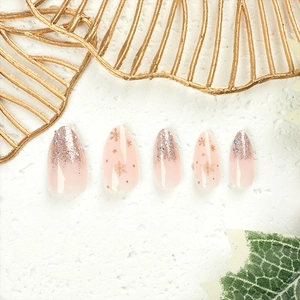 Christmas almond press-on nails with golden snowflakes and pink purple glitter gradient