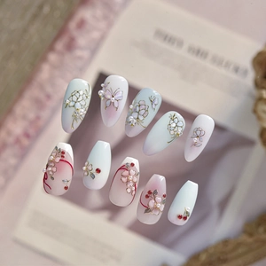 Exquisite handmade press-on nails featuring 3D embossed flowers, butterflies, and pearls