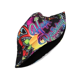 Macro view of reversible bucket hat featuring colorful Happy Birthday graffiti print