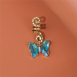 Detail of golden spiral hair braid cuff with a blue crystal butterfly charm pendant