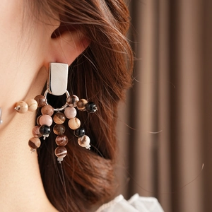 Close-up of vintage beaded earrings featuring silver plate and multi-color natural stones