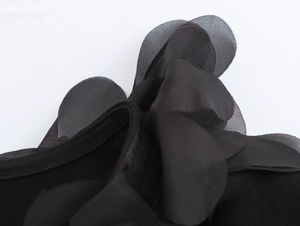 Close-up detail of layered black mesh lace trim on a stylish V-neck long sleeve blouse