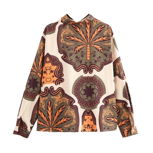 Detail of vintage beach shirt fabric featuring palm prints and silky smooth texture
