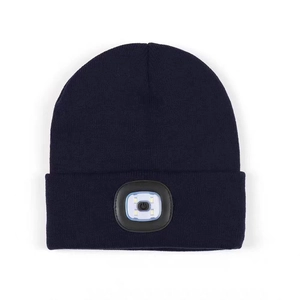 Dark blue knitted beanie featuring integrated LED light for outdoor illumination