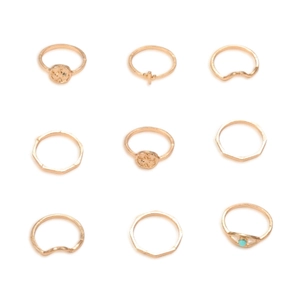 Set of 9 minimalist gold rings featuring geometric wave designs and a turquoise gemstone