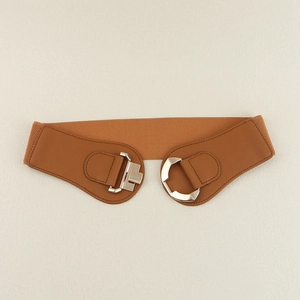 Detailed view of brown elastic waist belt with geometric silver buckle and leather accents