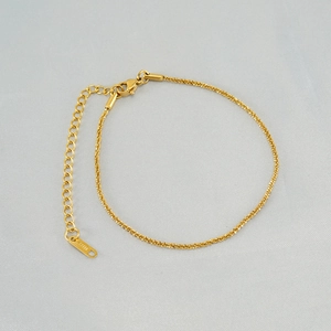Macro detail of 18K gold plated stainless steel anklet with lobster clasp and extender