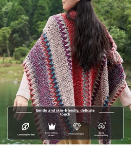 Detail of bohemian retro shawl with geometric patterns and fringe in a forest setting