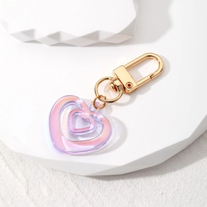 Detail view of colorful heart-shaped laser acrylic keychain with golden metal U-hook
