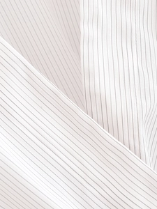 Macro shot of breathable pinstripe woven fabric with black stripes on white base