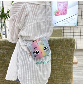 Detailed back view of child model wearing a rainbow cat mini crossbody bag with a chain