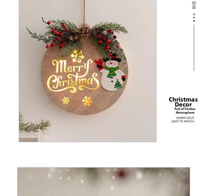 Detail of wooden Merry Christmas hanging plaque with LED light, snowmen, and pine cones