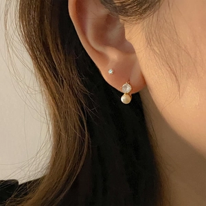 Elegance 925 silver gold-plated earrings with pearls and cubic zirconia on a model
