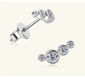 Close-up of S925 sterling silver pea-shaped earrings with graduated white moissanite stones