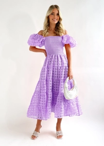 Detail of purple plaid off-shoulder dress featuring puffy sleeves and tiered ruffle skirt